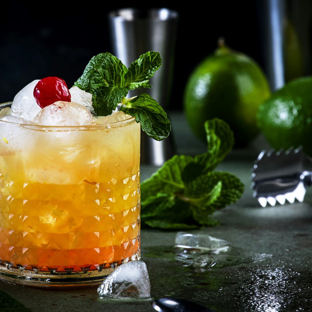 Mai Tai alcoholic cocktail with rum, liqueur, syrup, lime juice, mint and crushed ice